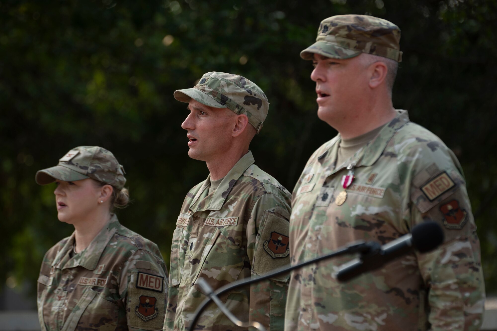 (From left to right) U.S. Air Force Col. Angela Lacek, 47th Medical Group commander, Lt. Col. Daniel Griffith, current 47th Healthcare Operations Squadron (HCOS) commander, and Lt. Col. Neil Boots, former 47th HCOS commander, stand at attention singing the Air Force song during the 47th HCOS change of command ceremony at Laughlin Air Force Base, Texas, June 7, 2024. Change of command ceremonies represent a formal transfer of authority and responsibility for a unit from one commanding officer to another. (U.S. Air Force photo by Senior Airman Kailee Reynolds)
