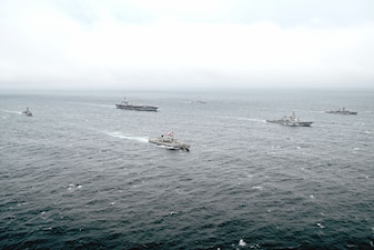 USS George Washington (CVN 73), center, transits the Pacific Ocean with Chilean navy ships.