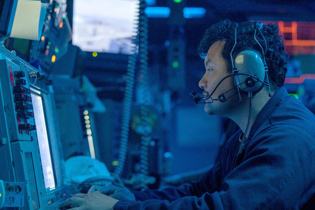 Lt. David Escalera stands watch in CIC aboard USS Higgins (DDG 76) during  Valiant Shield 2024.
