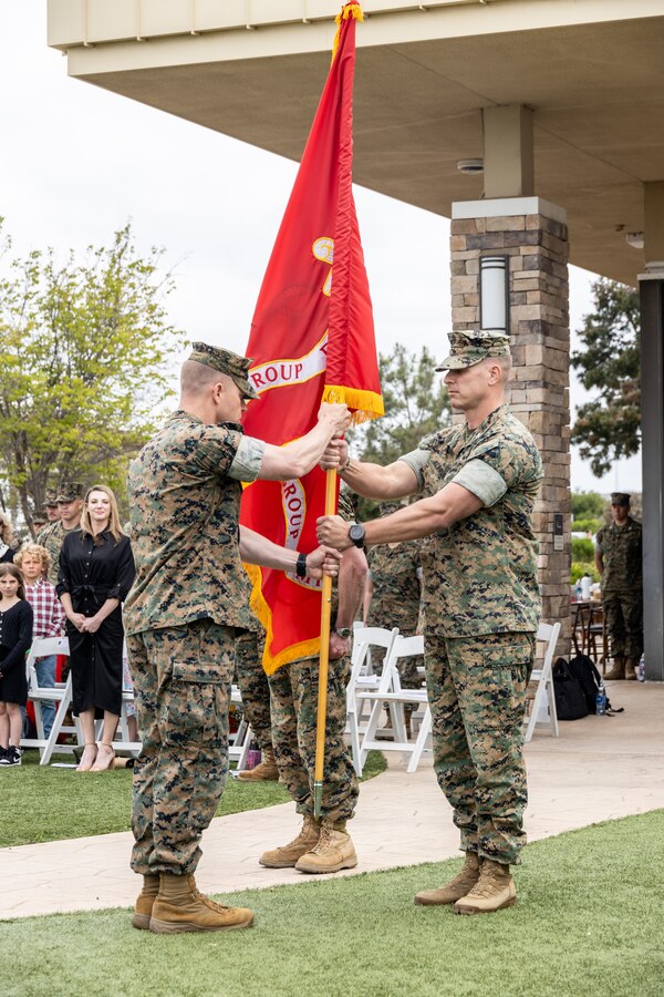 U.S. Marine Corps Col. Michael T. Aldridge, right, the incoming commanding officer of 1st Civil Affairs Group, Marine Corps Forces Reserves, passes the colors to Sgt. Maj. Robert K. Lusk, left, the sergeant major of 1st CAG, during a change of command ceremony at Marine Corps Base Camp Pendleton, California, May 18, 2024. A change of command ceremony is a military tradition that represents a formal transfer of authority and responsibility for a unit from one commanding officer to another. (U.S. Marine Corps photo by Lance Cpl. Mhecaela J. Watts)