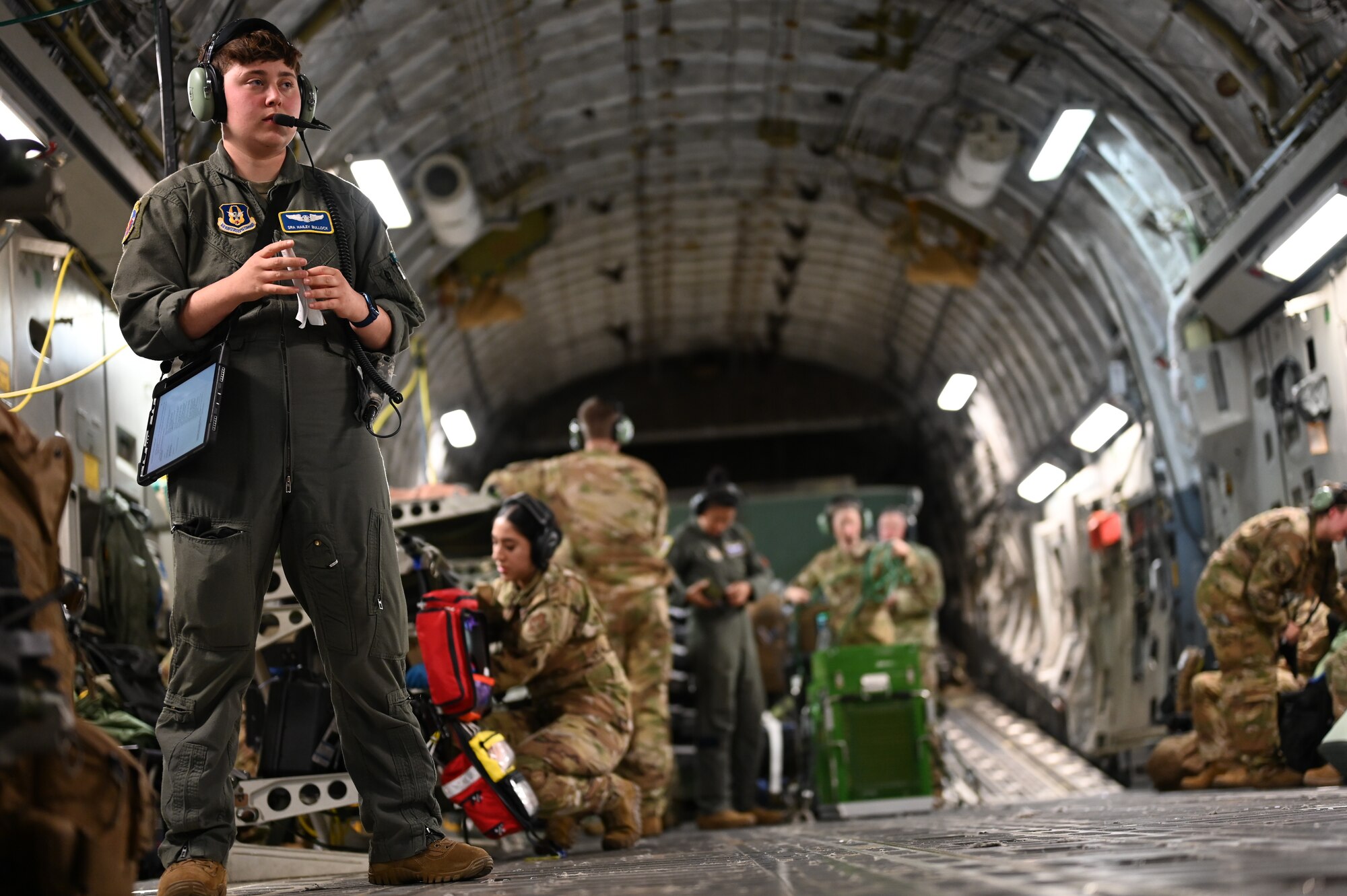 Senior Airman Hailey Bullock, a 445th Aeromedical Evacuation Squadron medical technician, looks on as members from both the 445th AES and 349th AES from Travis Air Force Base, California, prepare for the return flight home after making stops at Joint Base Elmendorf-Richardson, Alaska, and Joint Base Pearl Harbor-Hickam, Hawaii, May 12, 2024.