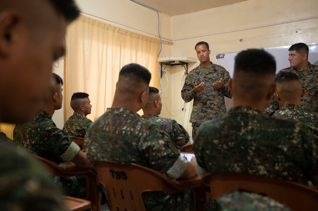 U.S. Navy Hospital Corpsman 1st Class Andruw Jones, a psychological technician with Marine Aircraft Group 13, 3rd Marine Aircraft Wing, introduces himself to Philippine Marines at a tactical combat casualty care class during Marine Aviation Support Activity 24 at Fort Bonifacio, Manila, Philippines, June 10, 2024. TCCC courses cover three phases: care under fire, tactical field care, and casualty evacuation procedures. MASA is an annual Philippine-U.S. military exercise focused on mutual defense, strengthening relationships, and rehearsing emerging aviation concepts. Jones is a native of Minnesota. (U.S. Marine Corps photo by Cpl. Kayla Halloran)