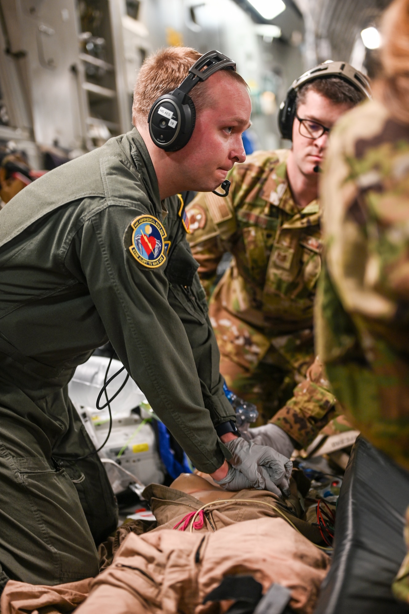 Staff Sgt. Eric Lovingshimer, does chest compressions on a “patient” onboard a C-17 Globemaster III during an AE training flight May 5, 2024. Twelve Citizen Reserve Airmen with the 445th Airlift Wing and 12 members with the 349th AES at Travis AFB, California, trained on a C-17 in several locations during their annual training May 8-13, 2024.This particular training mission, a cross-country aeromedical evacuation flight, ensured Reserve AES Airmen maintained the skills needed in a deployed environment.