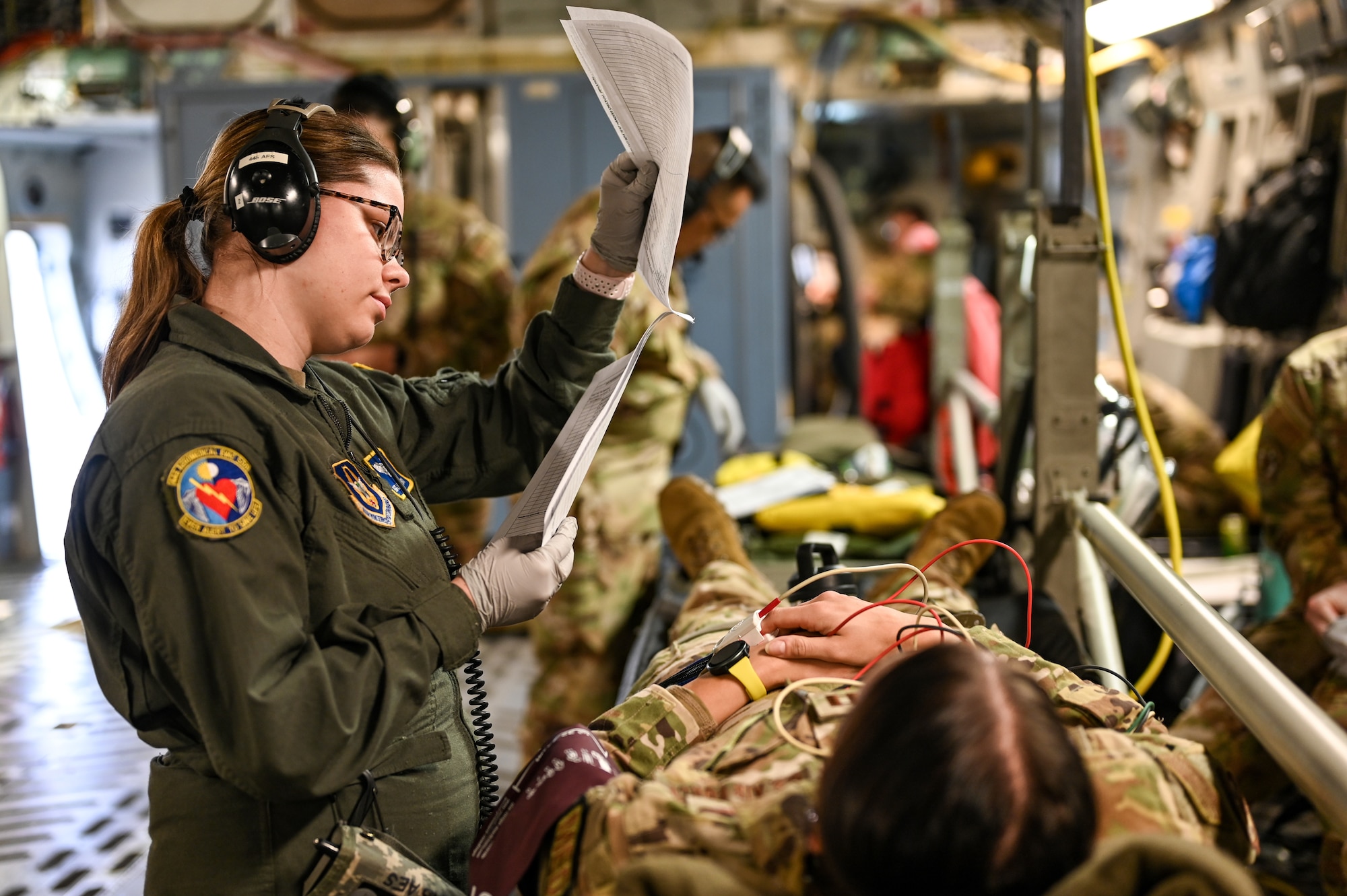 Staff Sgt. Jennifer Brann, 445th Aeromedical Evacuation Squadron medical technician, checks the paperwork of a “patient” onboard a C-17 Globemaster III during an AE training flight May 11, 2024. Twelve Citizen Reserve Airmen with the 445th Airlift Wing and 12 members with the 349th AES at Travis AFB, California, trained on a C-17 in several locations during their annual training May 8-13, 2024.