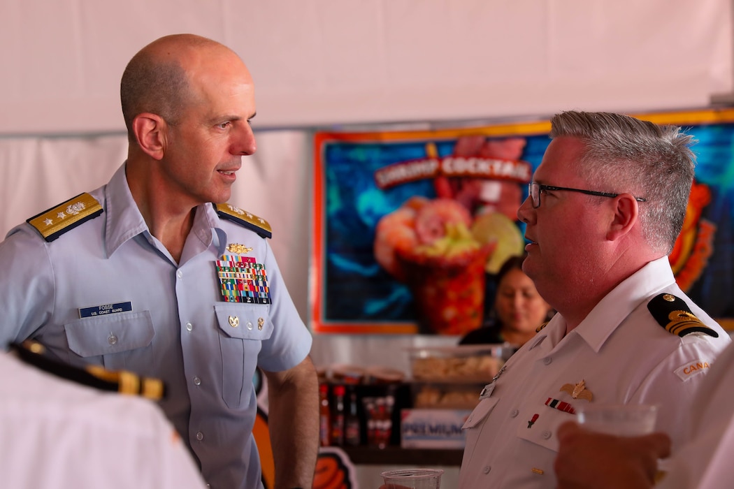 U.S. Coast Guard Rear Adm. Charles Fosse, Commander of the 13th Coat Guard District and Royal Canadian Navy Lt. Cdr. Les Gunderson speak with eachother during a Sip to Shore Reception for Portland Fleet Week June 6, 2024. Portland Fleet Week is a time-honored celebration of the sea services and provides an opportunity for the citizens of Oregon to meet Sailors, Marines and Coast Guardsmen, as well as witness firsthand the latest capabilities of today’s maritime services. (U.S. Navy photo by Mass Communication Specialist 3rd Class Justin Ontiveros)