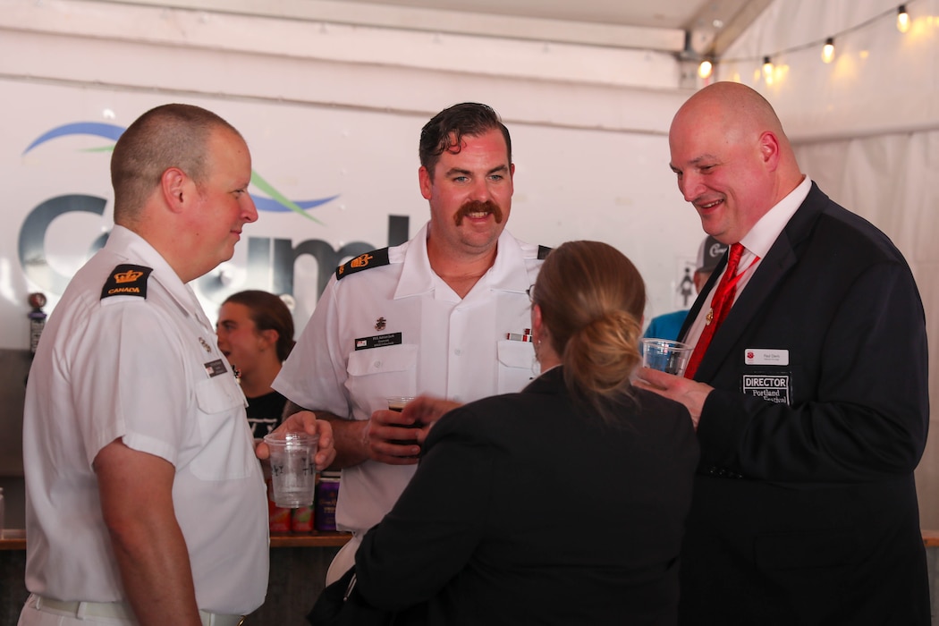 Royal Canadian Navy Petty Officer 1st Class Terry Thomas and Petty Officer 1st Class Adrian Jack speak with Paul Davis, Director for the Portland Rose Festival and Victoria Davis during a Sip to Shore Reception for Portland Fleet Week June 6, 2024. Portland Fleet Week is a time-honored celebration of the sea services and provides an opportunity for the citizens of Oregon to meet Sailors, Marines and Coast Guardsmen, as well as witness firsthand the latest capabilities of today’s maritime services. (U.S. Navy photo by Mass Communication Specialist 3rd Class Justin Ontiveros)