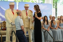 U.S. Coast Guard Rear Adm. Charles Fosse, Commander of the 13th Coast Guard District, is knighted by Rose Festival Queen Deja Fitzwater during the Royal Rosarians Honorary Knighting Ceremony as part of Portland Fleet Week June 7, 2024. Portland Fleet Week is a time-honored celebration of the sea services and provides an opportunity for the citizens of Oregon to meet Sailors, Marines and Coast Guardsmen, as well as witness firsthand the latest capabilities of today’s maritime services. (U.S. Navy photo by Mass Communication Specialist 3rd Class Justin Ontiveros)