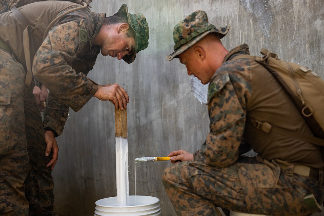 U.S. Marines with 3rd Littoral Combat Team, 3rd Marine Littoral Regiment, 3rd Marine Division, paint a local school during the maritime key terrain security operations event of Balikatan 24 at Itbayat, Philippines, May 7, 2024. The event was conducted alongside Philippine Marines with Marine Battalion Landing Team 10. BK 24 is an annual exercise between the Armed Forces of the Philippines and the U.S. military designed to strengthen bilateral interoperability, capabilities, trust, and cooperation built over decades of shared experiences. (U.S. Marine Corps photo by Cpl. Malia Sparks)
