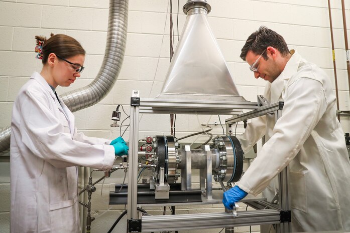 Naval Surface Warfare Center Indian Head Division’s Novel Metal Fuel and Synthesis Combustion Team of Emma Skekel (left) and Dr. Demitrios Stamatis (right) are the recipients of a 2024 Dr. Delores M. Etter Top Scientist and Engineering team award for designing and developing a constant volume combustion (CVC) vessel. The CVC uses only gram amounts of material, saving time and money. This capability has improved metal fuel development and ultimately aims to improve range, speed and lethality of weapons systems. (U.S. Navy photo released)