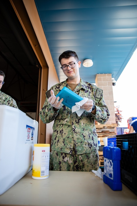 Gunner's Mate 3rd Class Smithfield Latkanich assigned to the Independence-variant littoral combat ship USS Gabrielle Giffords (LCS 10) assists in organizing food and supplies to be distributed to the community as a part of the annual Rose Festival during Portland Fleet Week in Portland, Oregon, June 7, 2024. Portland Fleet Week is a time-honored celebration of the sea services and provides an opportunity for the citizens of Oregon to meet Sailors, Marines and Coast Guardsmen, as well as witness firsthand the latest capabilities of today’s maritime services. (U.S. Navy photo by Mass Communication Specialist 2nd Class Jordan Jennings)