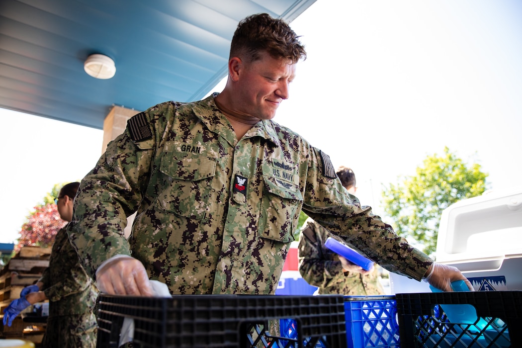 Electronics Technician 1st Class Kevin Gran assigned to the Independence-variant littoral combat ship USS Montgomery (LCS 8) assists in organizing food and supplies to be distributed to the community as a part of the annual Rose Festival during Portland Fleet Week in Portland, Oregon, June 7, 2024. Portland Fleet Week is a time-honored celebration of the sea services and provides an opportunity for the citizens of Oregon to meet Sailors, Marines and Coast Guardsmen, as well as witness firsthand the latest capabilities of today’s maritime services. (U.S. Navy photo by Mass Communication Specialist 2nd Class Jordan Jennings)