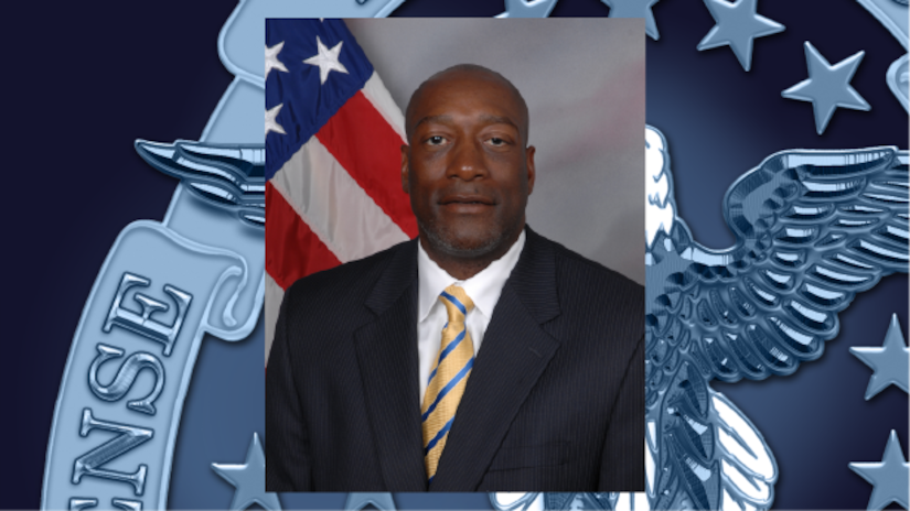 A graphic shows a photo of a man in a business suit superimposed over the Defense Department seal.