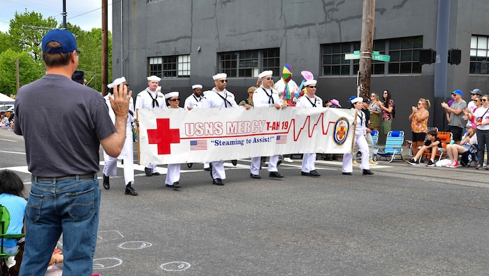 Sailors assigned to the hospital ship hospital ship USNS Mercy (T-AH 19) march in the Grand Floral Parade during the annual Portland Fleet Week and Rose Festival in Portland, Oregon June 8, 2024. Portland Fleet Week is a time-honored celebration of the sea services and provides an opportunity for the citizens of Oregon to meet Sailors, Marines and Coast Guardsmen, as well as witness firsthand the latest capabilities of today’s maritime services. (U.S. Navy photo by Mass Communication Specialist 1st Class Heather C. Wamsley)