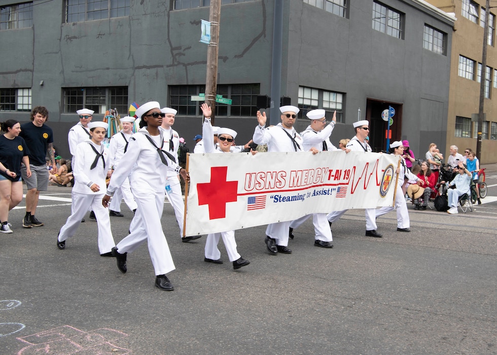 Sailors assigned to the hospital ship hospital ship USNS Mercy (T-AH 19) march in the Grand Floral Parade during the annual Portland Fleet Week and Rose Festival in Portland, Oregon June 8, 2024. Portland Fleet Week is a time-honored celebration of the sea services and provides an opportunity for the citizens of Oregon to meet Sailors, Marines and Coast Guardsmen, as well as witness firsthand the latest capabilities of today’s maritime services. (U.S. Navy photo by Mass Communication Specialist 1st Class Heather C. Wamsley)