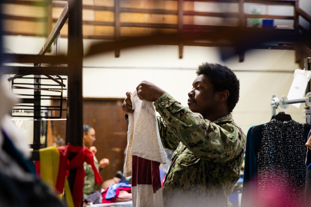 Engineman 2nd Class Jarvis Ashore assigned to the Independence-variant littoral combat ship USS Montgomery (LCS 8) sorts through donated clothing at a thrift store organized by Union Gospel Mission as a part of the annual Rose Festival during Portland Fleet Week in Portland, Oregon, June 8, 2024. Portland Fleet Week is a time-honored celebration of the sea services and provides an opportunity for the citizens of Oregon to meet Sailors, Marines and Coast Guardsmen, as well as witness firsthand the latest capabilities of today’s maritime services. (U.S. Navy photo by Mass Communication Specialist 2nd Class Jordan Jennings)