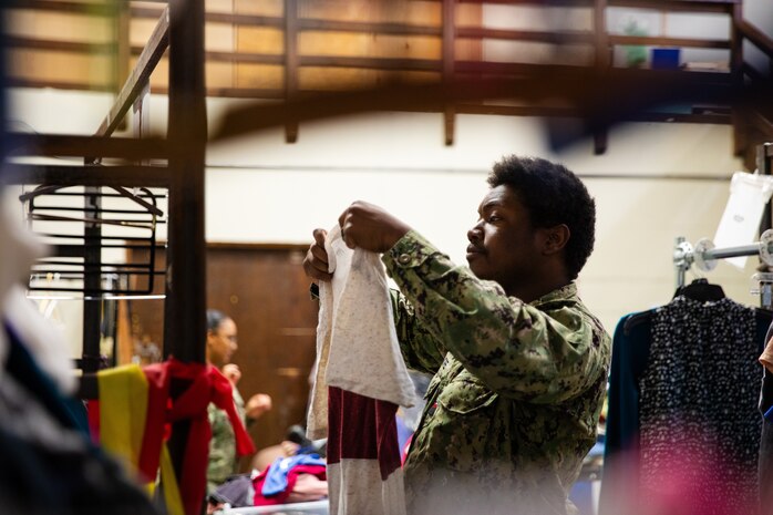 Engineman 2nd Class Jarvis Ashore assigned to the Independence-variant littoral combat ship USS Montgomery (LCS 8) sorts through donated clothing at a thrift store organized by Union Gospel Mission as a part of the annual Rose Festival during Portland Fleet Week in Portland, Oregon, June 8, 2024. Portland Fleet Week is a time-honored celebration of the sea services and provides an opportunity for the citizens of Oregon to meet Sailors, Marines and Coast Guardsmen, as well as witness firsthand the latest capabilities of today’s maritime services. (U.S. Navy photo by Mass Communication Specialist 2nd Class Jordan Jennings)