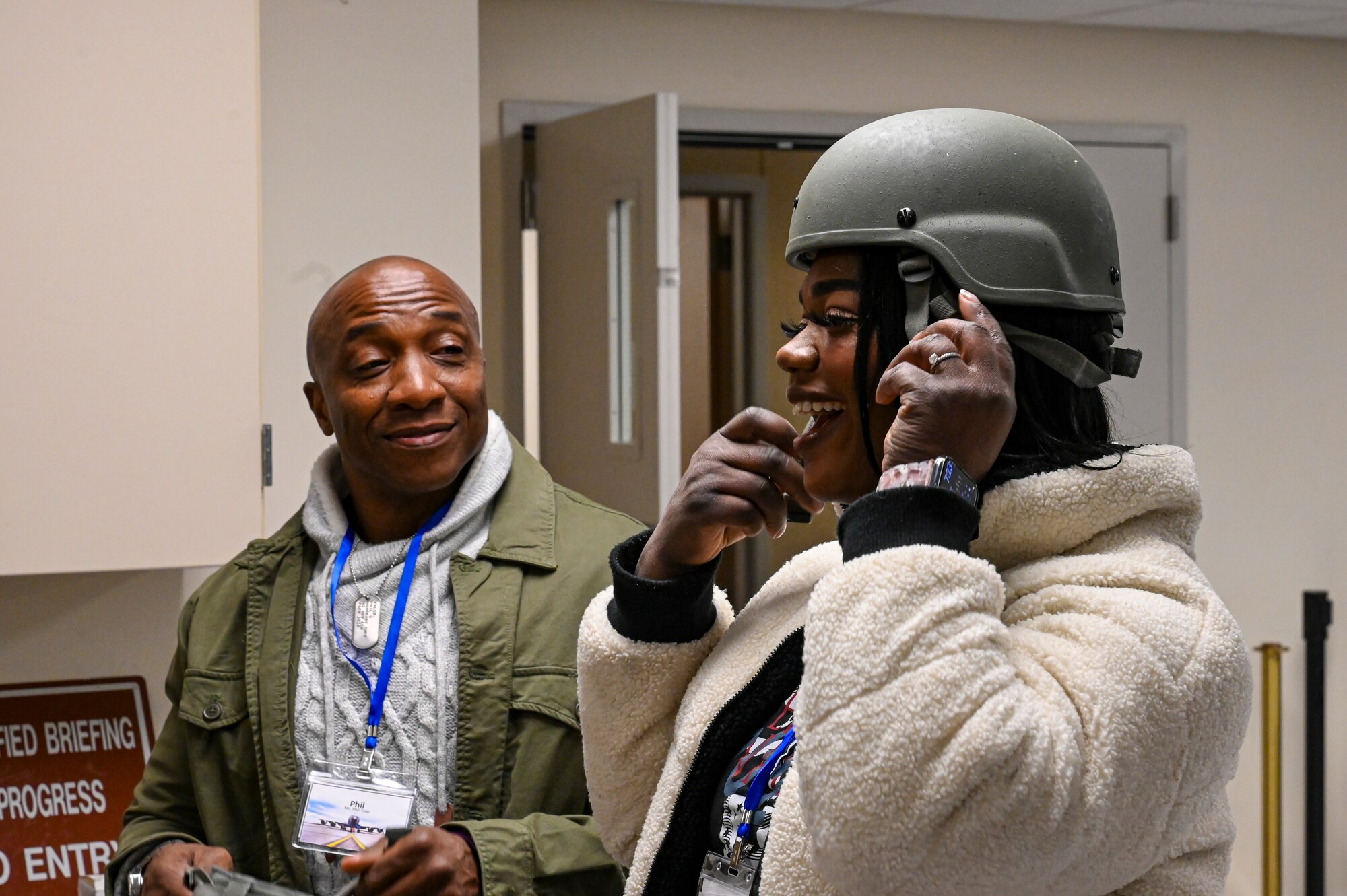 Honorary commander trys on helmet