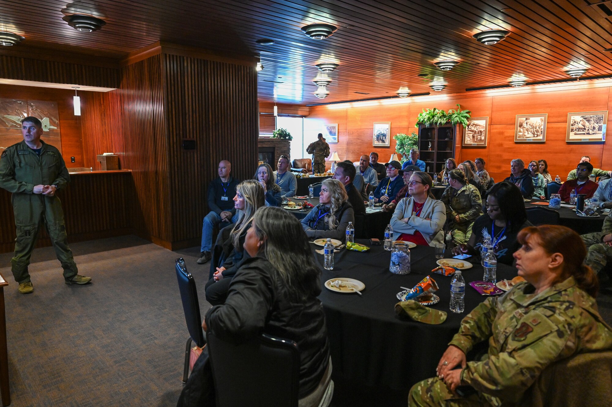 Honorary commanders listen to a brief