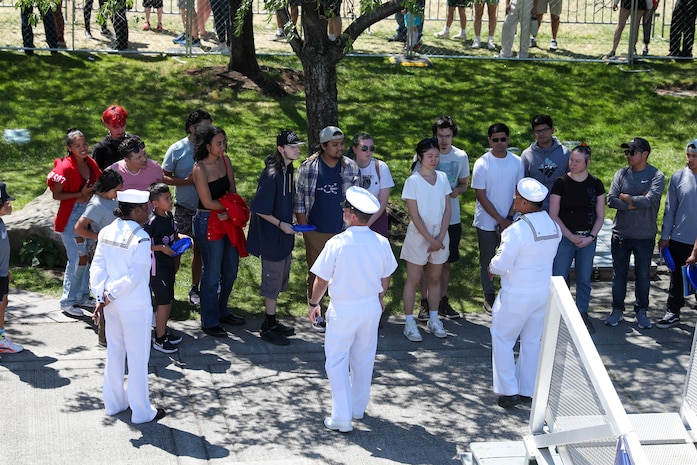 U.S. Navy Sailors stationed aboard the USS Montgomery (LSC-8) brief civilains before a tour of the Mongomery during Portland Fleet Week June 9, 2024. Portland Fleet Week is a time-honored celebration of the sea services and provides an opportunity for the citizens of Oregon to meet Sailors, Marines and Coast Guardsmen, as well as witness firsthand the latest capabilities of today’s maritime services. (U.S. Navy photo by Mass Communication Specialist 3rd Class Justin Ontiveros)