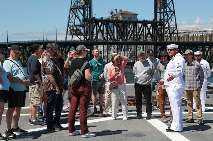 U.S. Navy Fire Controlman 1st Class Aaron Leonard  and Electronics Technician First Class Jason Rhoads conducts a tour of the USS Montgomery (LSC-8) during Portland Fleet Week June 9, 2024. Portland Fleet Week is a time-honored celebration of the sea services and provides an opportunity for the citizens of Oregon to meet Sailors, Marines and Coast Guardsmen, as well as witness firsthand the latest capabilities of today’s maritime services. (U.S. Navy photo by Mass Communication Specialist 3rd Class Justin Ontiveros)