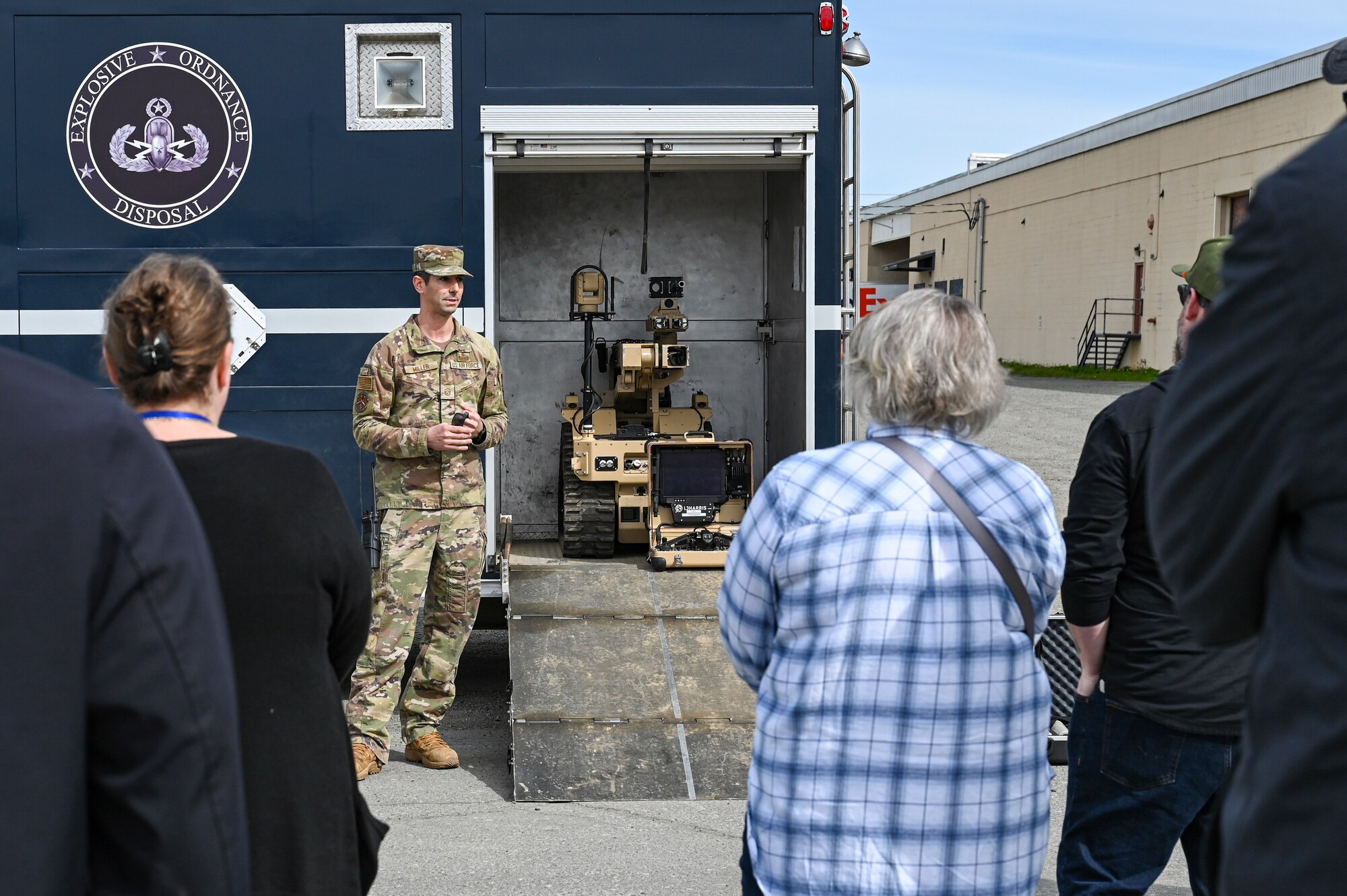 Airman stand next to truck