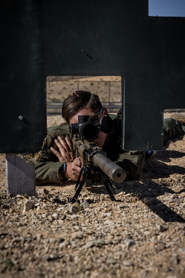 U.S. Marine Corps Cpl. Chase Johnson, a Houston, Texas native, team leader with the Provost Marshal's Office Special Reaction Team, Marine Air-Ground Task Force Training Command, Marine Corps Air-Ground Combat Center, sights into a M110 semi-automatic sniper system at rifle range 1A, MCAGCC, Twentynine Palms, California, June 5, 2024. SRT is a specialized team of military police officers trained to respond to high-risk and emergency calls in order to preserve life and contain incidents. The team conducted rifle qualifications as a part of their routine training. (U.S. Marine Corps photo by Lance Cpl. Iris Gantt)