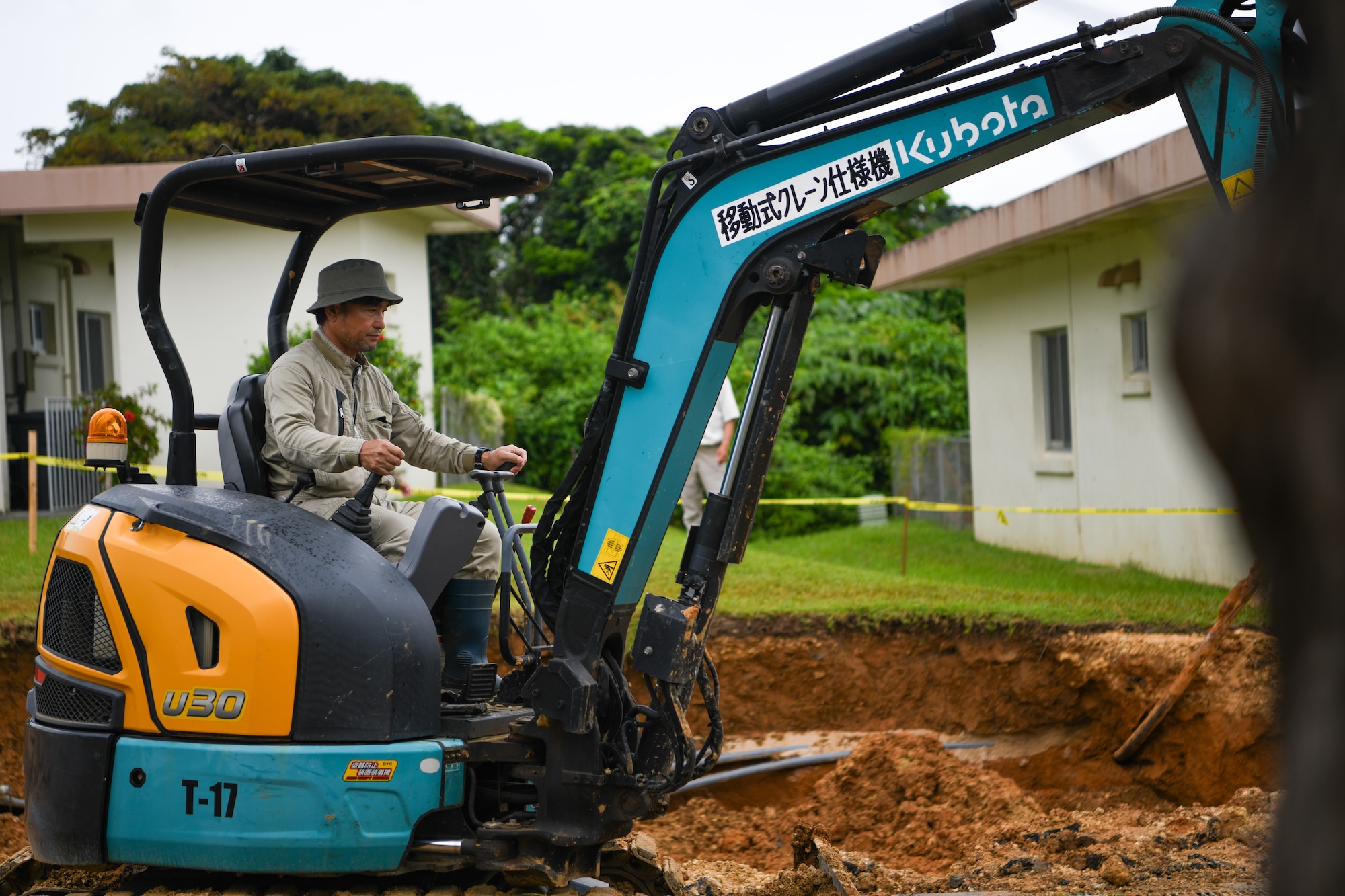 A Master Labor Contractor operates a mini-excavator.