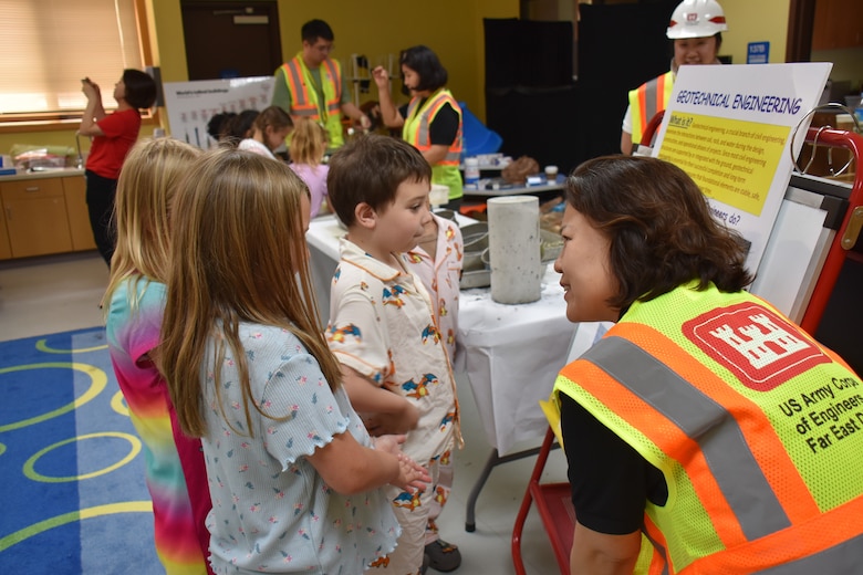 Ms. Sarah Woo, Engineering Division Chief, U.S. Army Corps of Engineers – Far East District, engages with students during a STEAM event hosted by USACE at West Elementary School on Camp Humphreys, South Korea, on May 25. Demonstrating how STEAM affects everything in the world, the team encourages students' curiosity and further interest in the field through hands-on activities. (U.S. Army photo by Rachel Napolitan)