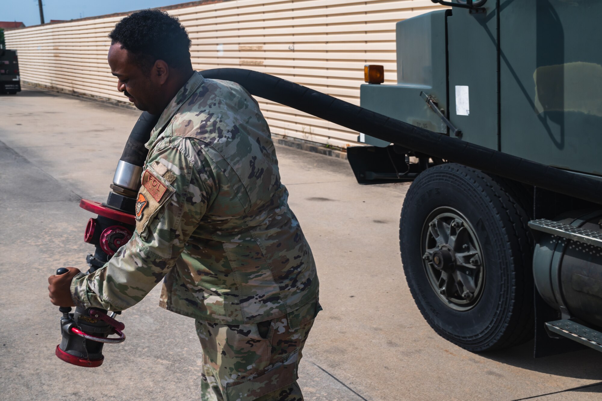 Senior Airman Darryus Jackson, 8th Logistics Readiness Squadron fuels facilities technician, removes a hose from an Oshkosh R-11 refueling unit