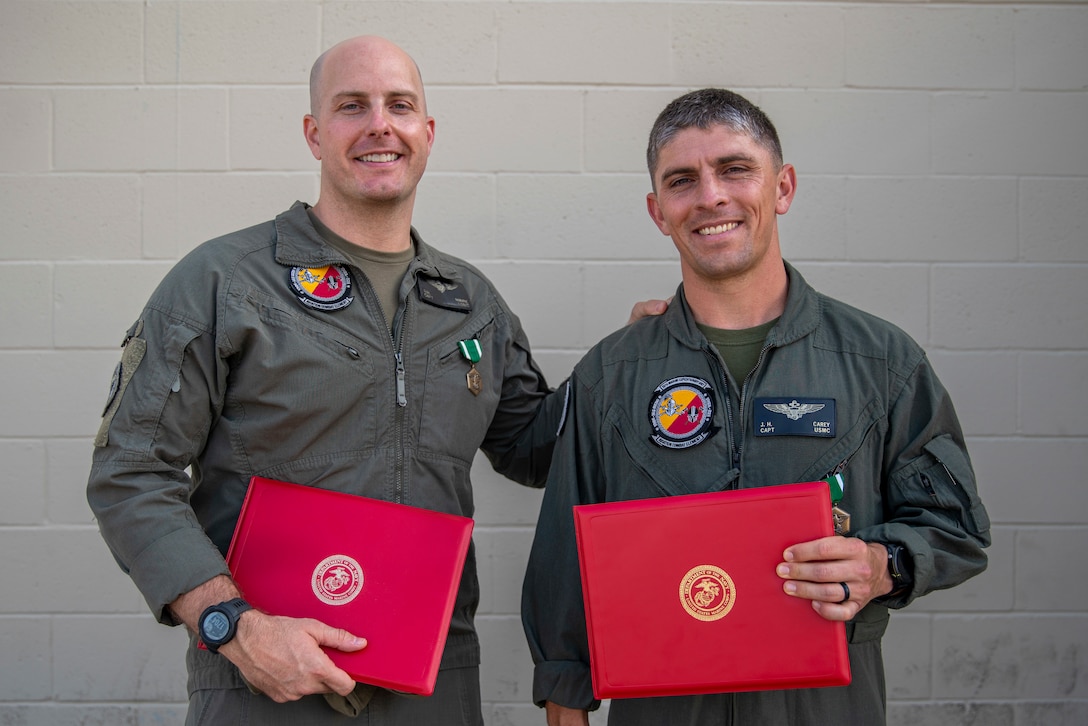 U.S. Marine Corps Capt. Steven Maire, left, an AH-1Z Viper pilot and a native of Cleveland, Ohio, and Capt. Joseph Carey, an MV-22B Osprey and a native of Hanover, New Hampshire, both assigned to Marine Medium Tiltrotor Squadron (VMM) 165 (Reinforced), 15th Marine Expeditionary Unit, pose for a photo after receiving Navy and Marine Corps Commendation Medals during a ceremony at Marine Corps Air Station Miramar, California, June 10, 2024. Maire and Carey were presented awards for providing lifesaving aid to a man suffering a medical emergency May 23, 2024, at Dallas Fort Worth International Airport. (U.S. Marine Corps photo by Cpl. Amelia Kang)