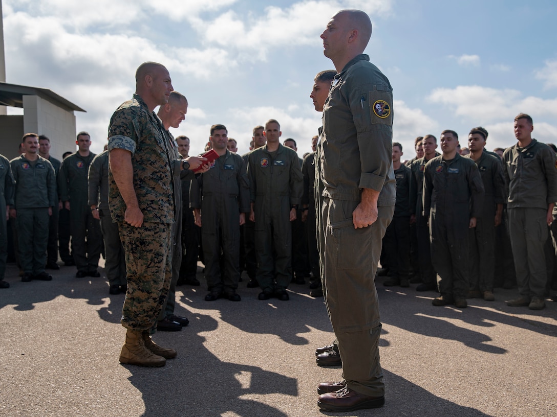 U.S. Marines assigned to Marine Medium Tiltrotor Squadron (VMM) 165 (Reinforced), 15th Marine Expeditionary Unit, stand in formation for an awards presentation at Marine Corps Air Station Miramar, California, June 10, 2024. Capt. Steven Maire and Capt. Joseph Carey were presented Navy and Marine Corps Commendation Medals for providing lifesaving aid to a man suffering a medical emergency May 23, 2024, at Dallas Fort Worth International Airport. (U.S. Marine Corps photo by Cpl. Amelia Kang)