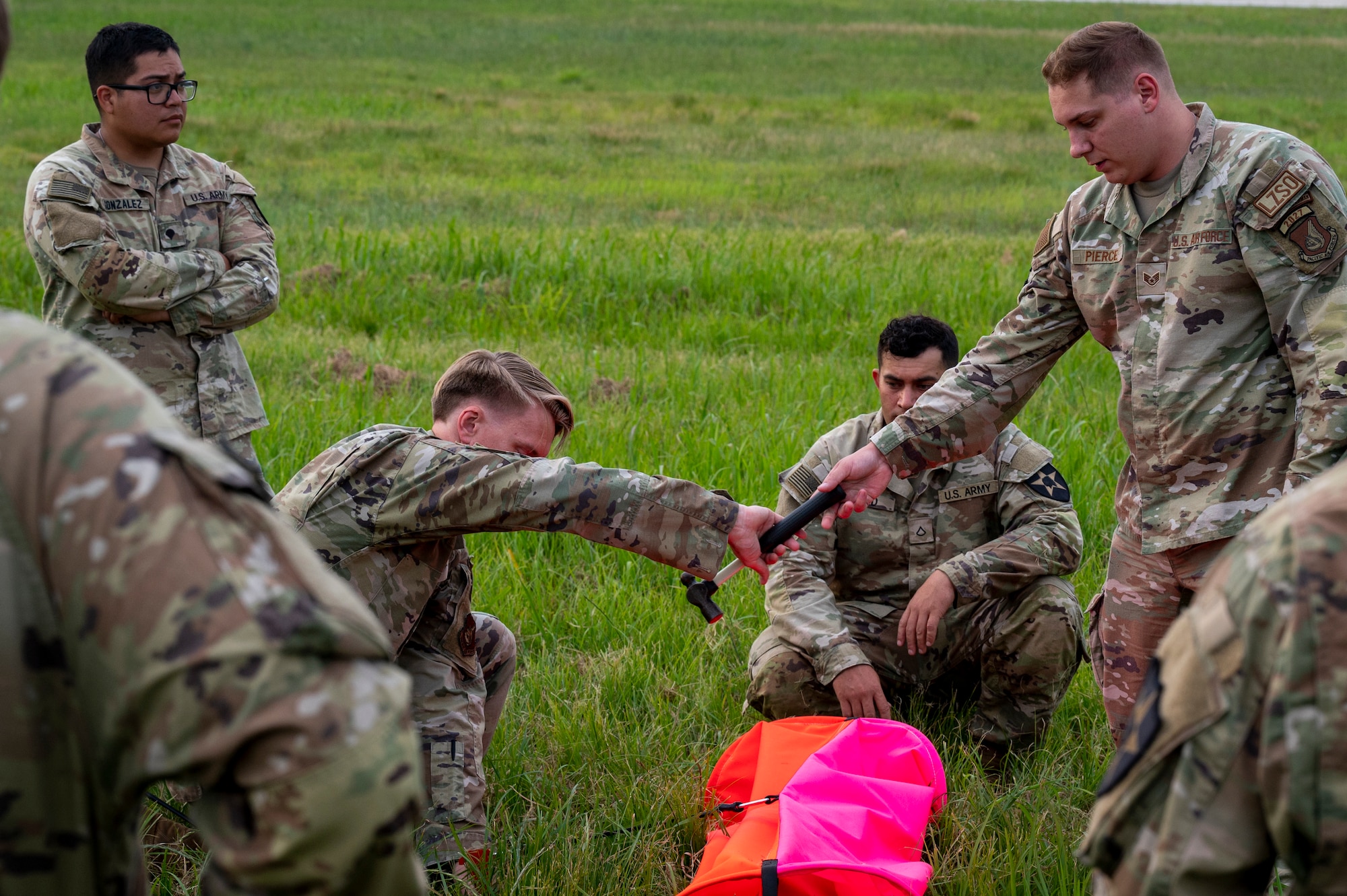 U.S. Air Force Airmen assigned to the 51st Operations Support Squadron and 607th Materiel Maintenance Squadron, and U.S. Soldiers assigned to the 3rd General Support Aviation Battalion, 2nd Combat Aviation Brigade, 2nd Infantry ROK/U.S. Combined Division, set up a visual marker during a joint training event at Osan Air Base, Republic of Korea, June 5, 2024. This integrated training demonstrates the 51st Fighter Wing's ability to operate with other United States Forces Korea units in defense of the peninsula by improving and aligning skill sets across the command. (U.S. Air Force photo by Senior Airman Sabrina Fuller-Judd)