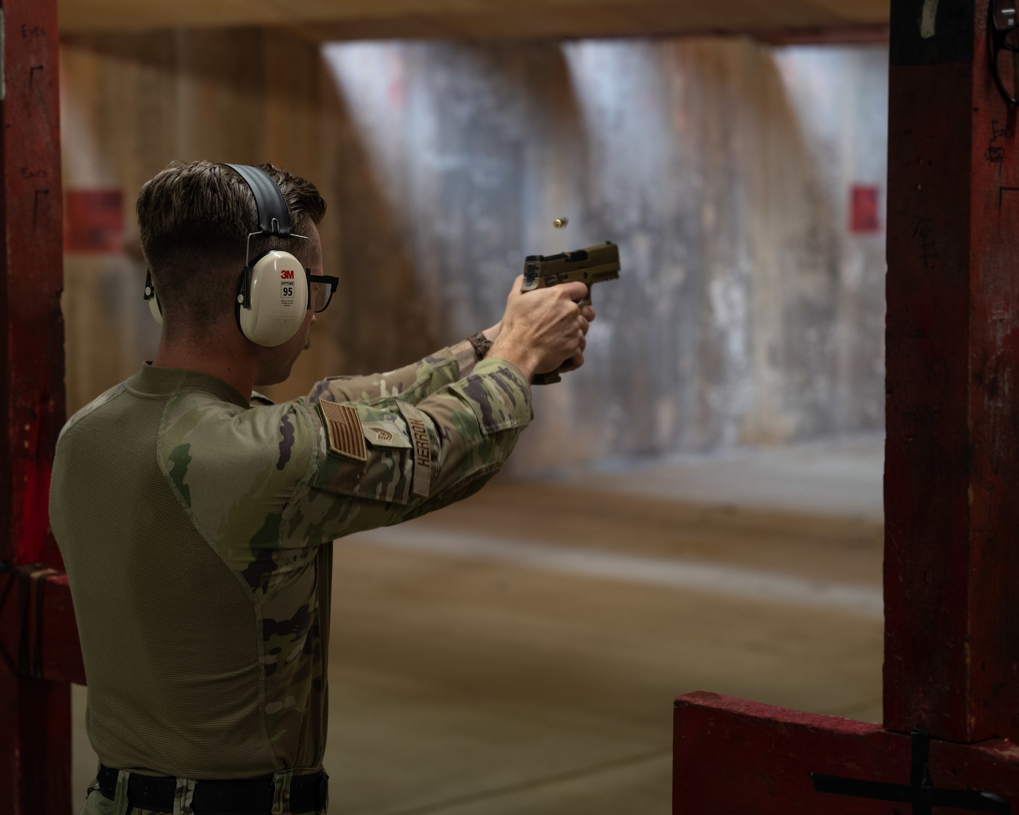 U.S. Air Force Tech. Sgt. Jeffery Herron, 8th Security Forces Squadron flight chief, fires an M18 handgun during the Excellence in Competition pistol match at Kunsan Air Base, Republic of Korea.