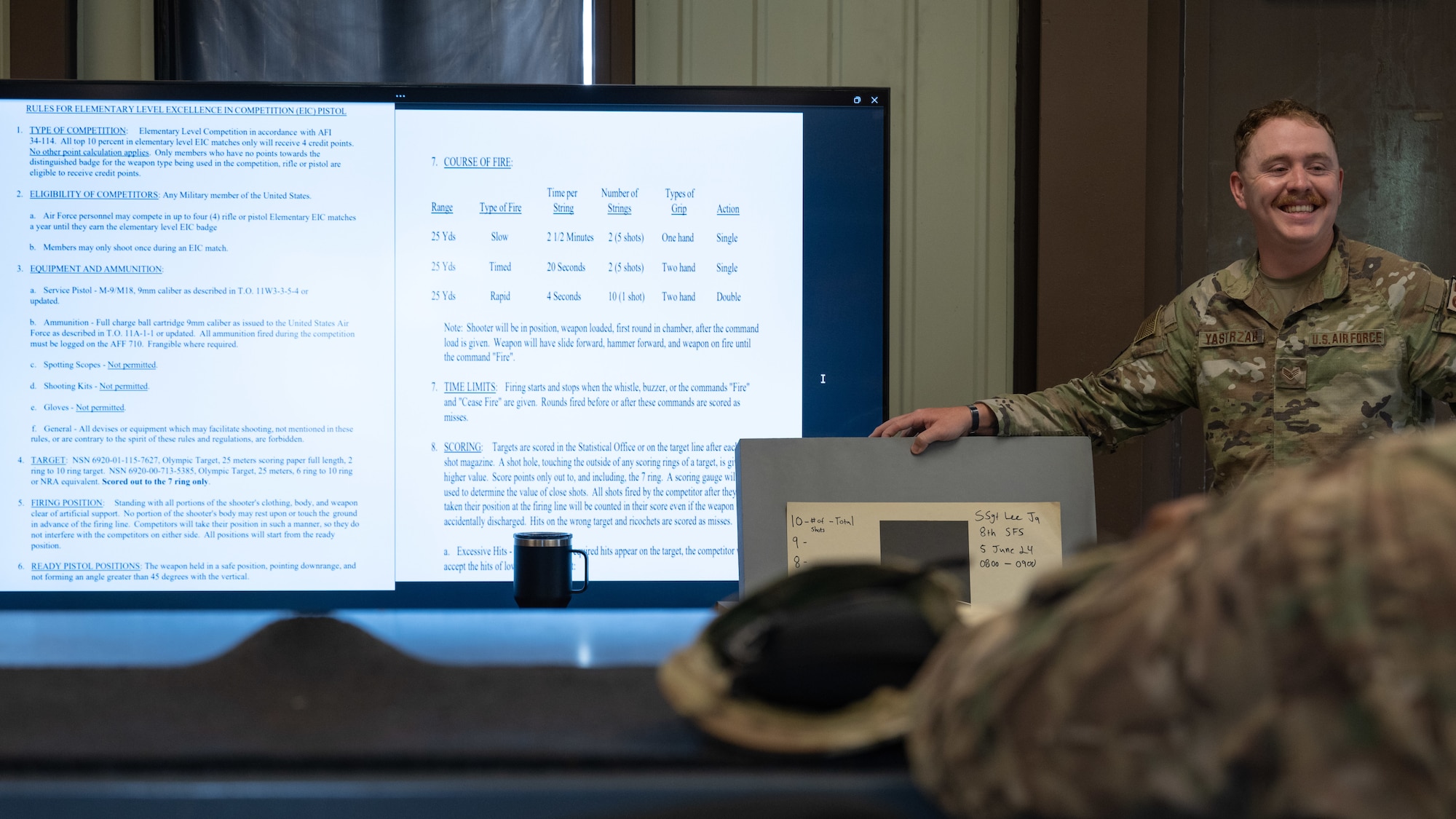 Senior Airman Victor Yastrzab, 8th Security Forces Squadron combat arms instructor, explains the Excellence in Competition rules with competitors at Kunsan Air Base, Republic of Korea.