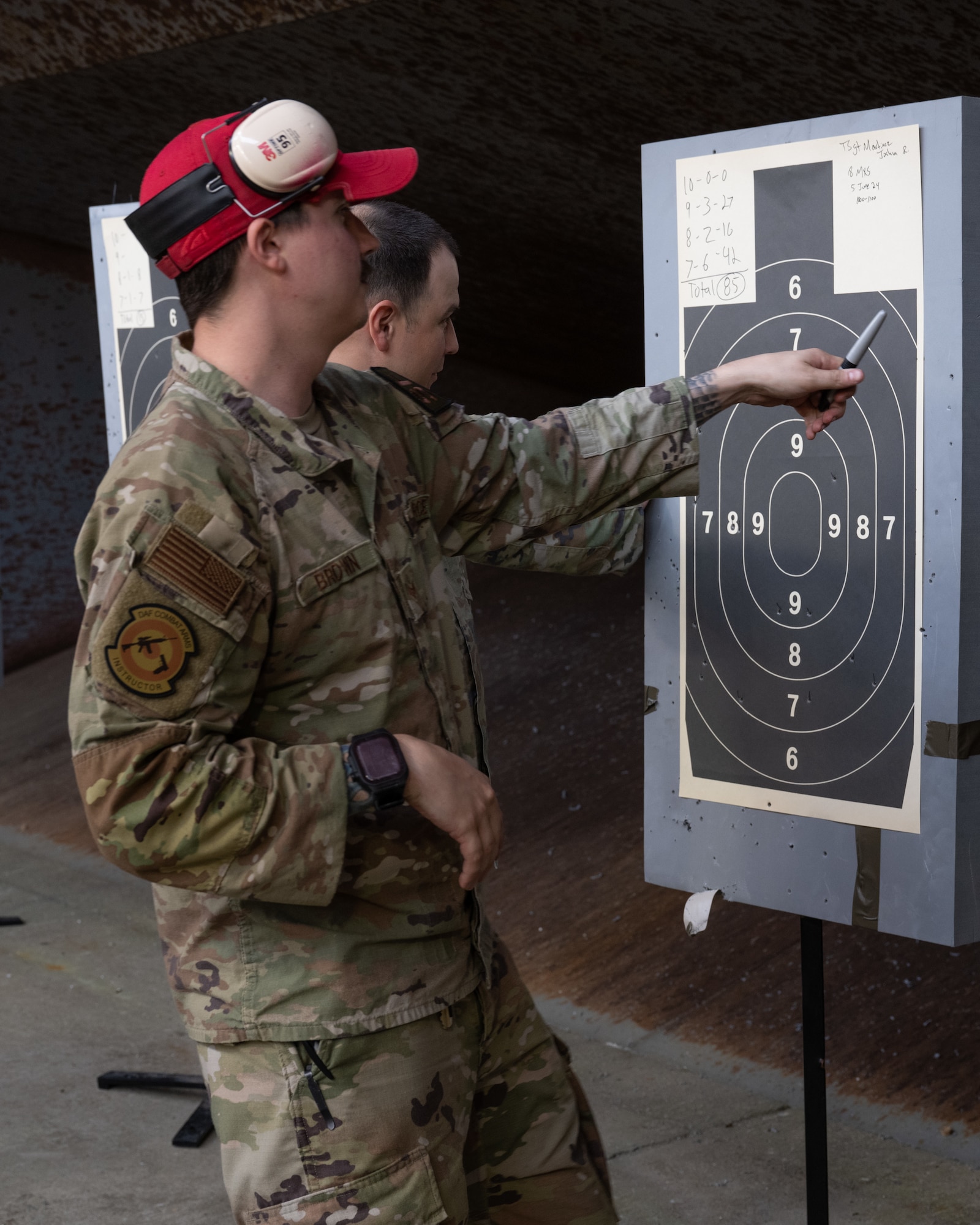 Senior Airman Tylor Brown, 8th Security Forces Squadron combat arms instructor, reviews target scores during an Excellence in Competition pistol match at Kunsan Air Base, Republic of Korea.