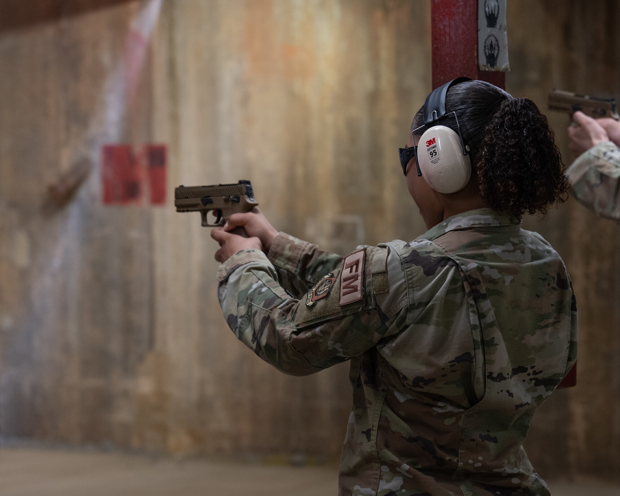 Senior Airman Jade Baker, 8th Comptroller Squadron financial analysis technician, fires an M18 handgun during the Excellence in Competition Pistol match at Kunsan Air Base, Republic of Korea.