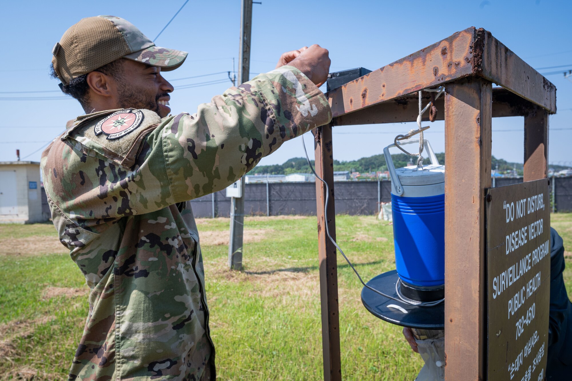 Senior Airman Darius McKay, 8th Operational Medical Readiness Squadron entomology program manager, sets up a carbon dioxide light trap during mosquito surveillance season.