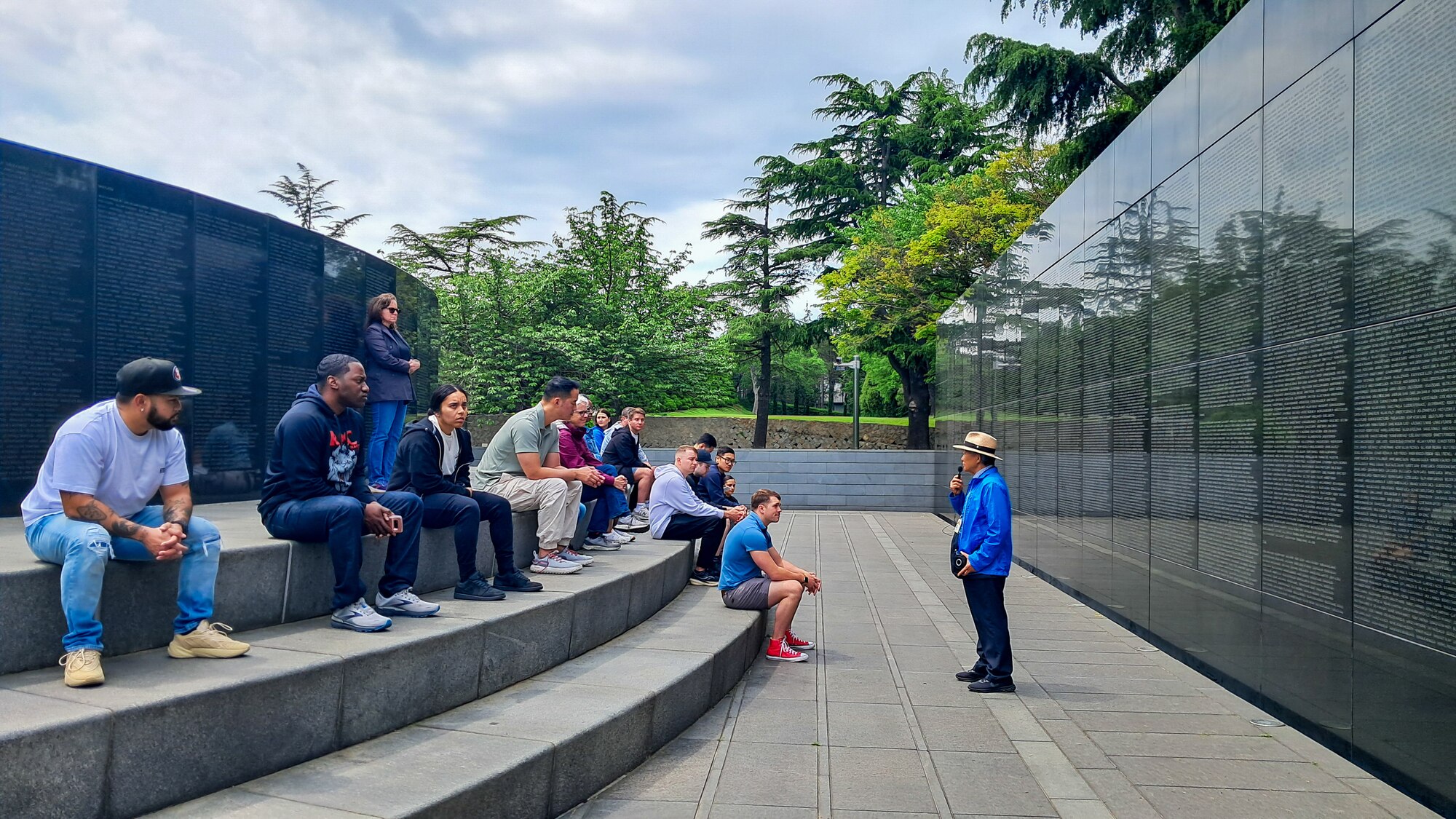 Visitors participating in the U.S. Forces Korea Korean Cultural Immersion Program observe a wall inscribed with the names of fallen U.S. servicemembers who were lost during the Korean War at the United Nations Memorial Cemetery in Busan, Republic of Korea, May 1, 2024.