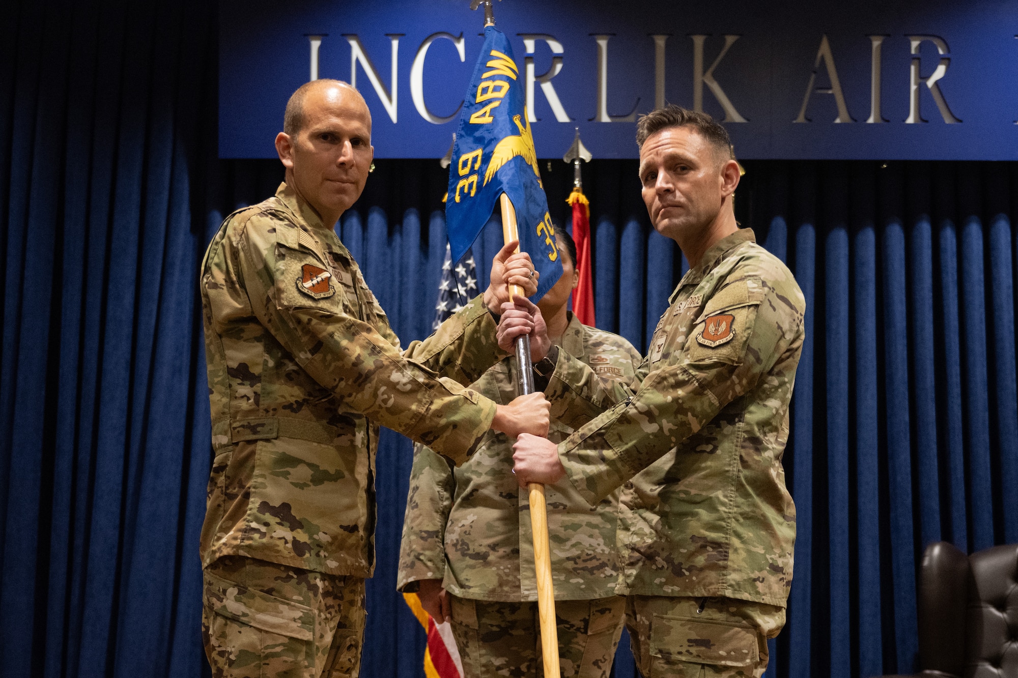 U.S. Air Force Col. Kevin Lord, 39th Air Base Wing commander, transfers the unit guidon to Col. John Jansheski, 39th Weapons System Security Group commander, during a change of command ceremony.