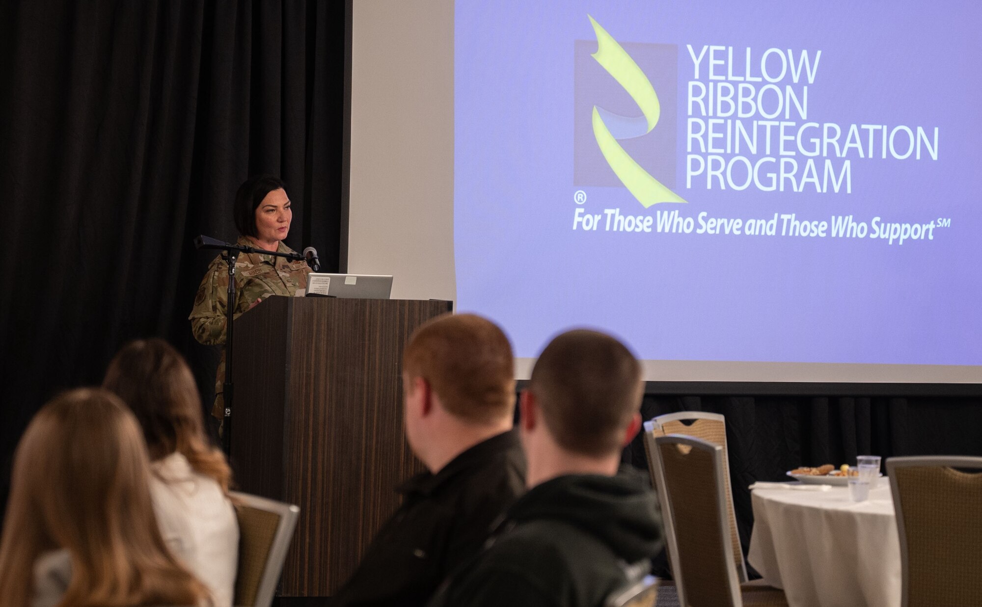 A general officer speaking to attendees about the information and resources available to them.