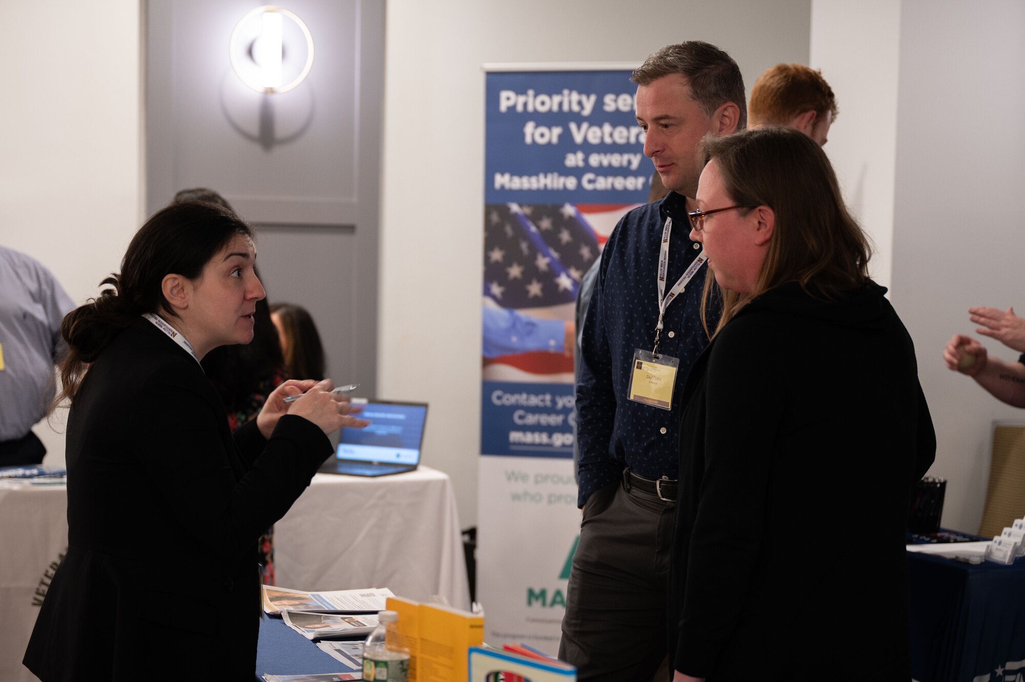 Event participants speaking with service members and family about services they provide.