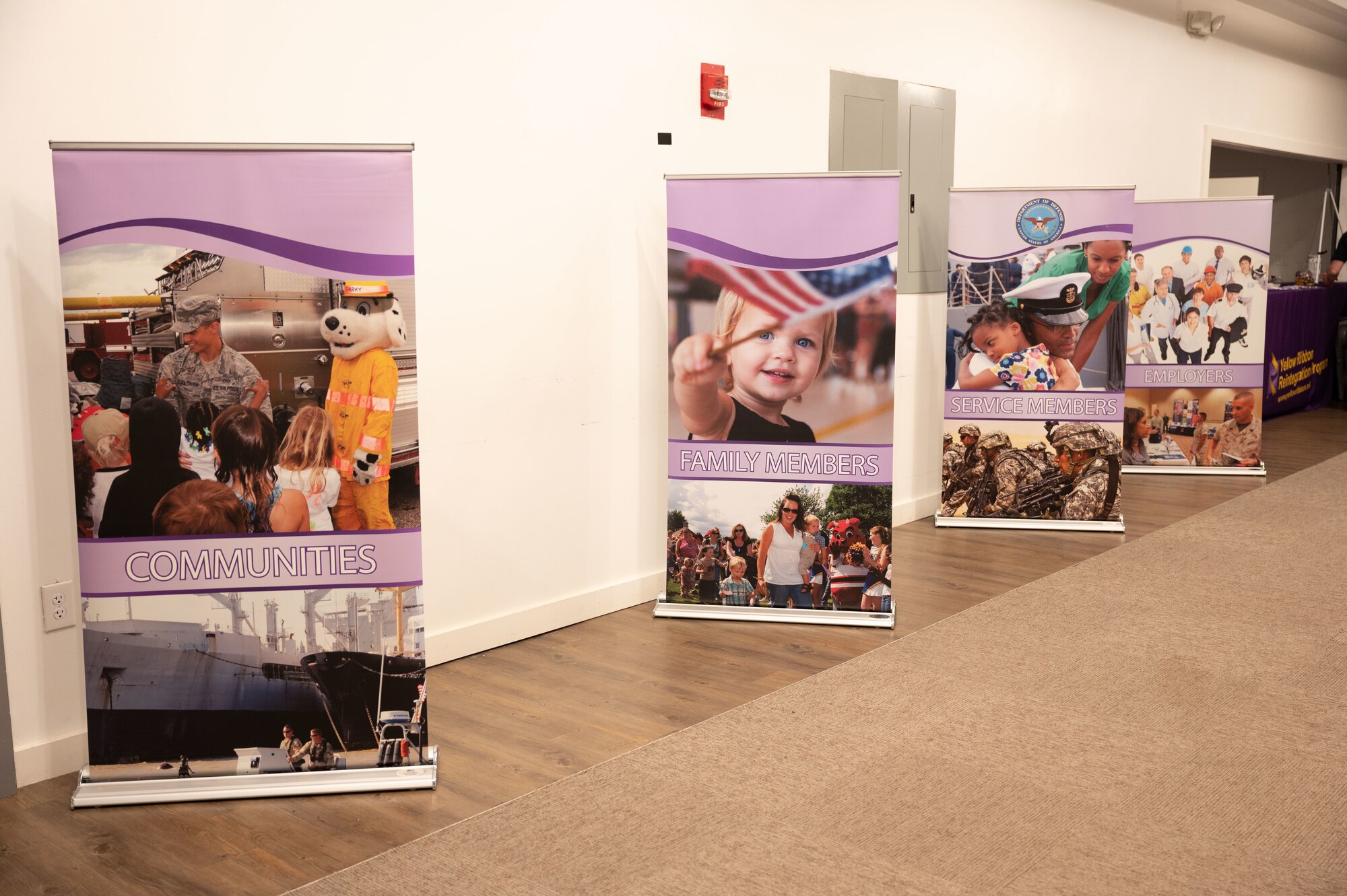 A photo of free standing displays with photos of deployers and their families.