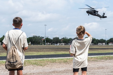 Children watching a helicopter land.