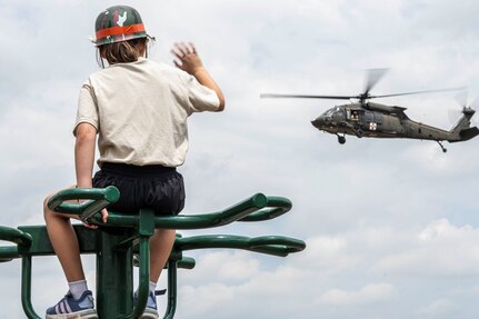 Child waiving at helicopter