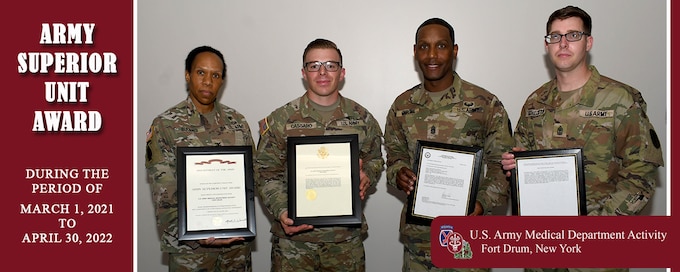 Photo graphic of Fort Drum MEDDAC and MEDCO command teams presenting Army Superior Unit Award certificate and memo.