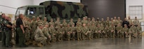 Illinois Army National Guard Soldiers and law enforcement officers from the Illinois State Police and the Williamson County Sheriff's Office pose for a photo with 7-year-old Jamir Gibbs of Marion, Illinois, after Jamir's "promotion" ceremony.