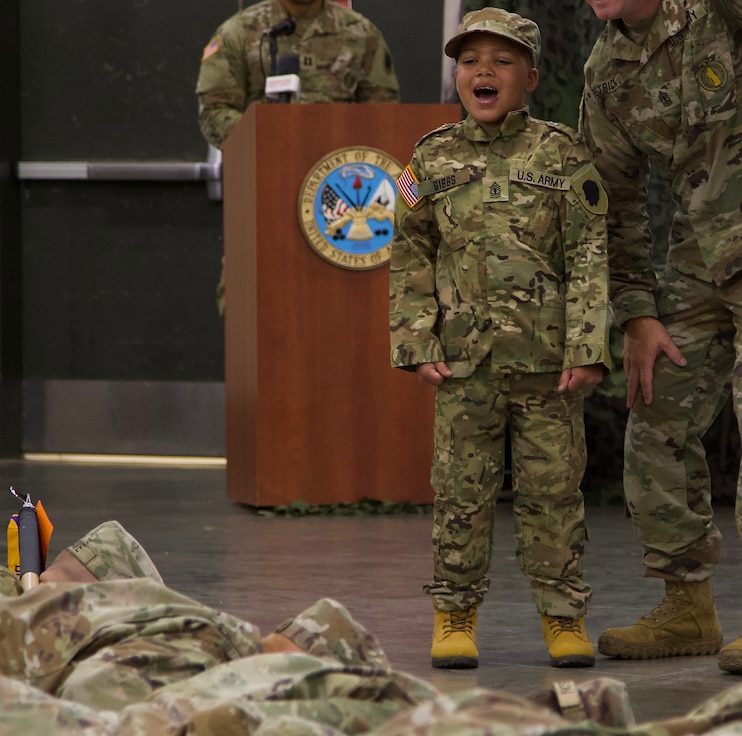 Seven-Year-Old Jamir Gibbs of Marion, Illinois, "smokes" a formation of Soldiers with 1st Sgt. Beau Detrick of November Company, Recruit Sustainment Program, Illinois Army National Guard Recruiting and Retention Command.