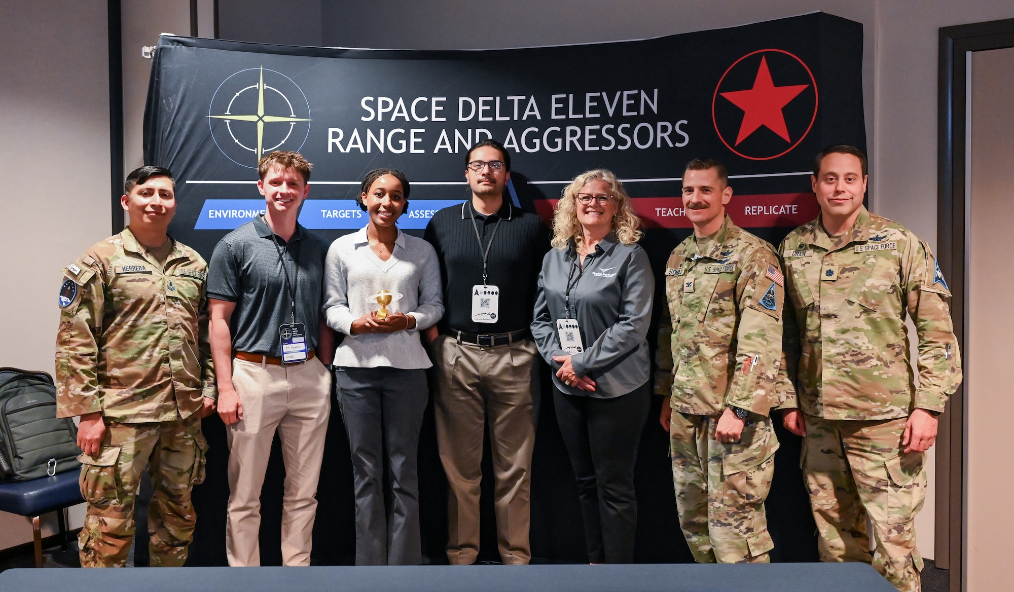 Winners of the National Space Test and Training Complex (NSTTC) Users’ Conference "Capture the Flag" event pose for a group photo at Peterson Space Force Base, Colo., June 5, 2024. The event aimed to educate attendees on range and aggressor capabilities, provide onboarding guidance, and foster discussions among key stakeholders who rely on Delta 11 for realistic training. (U.S. Air Force photo by Capt. Charles Rivezzo)