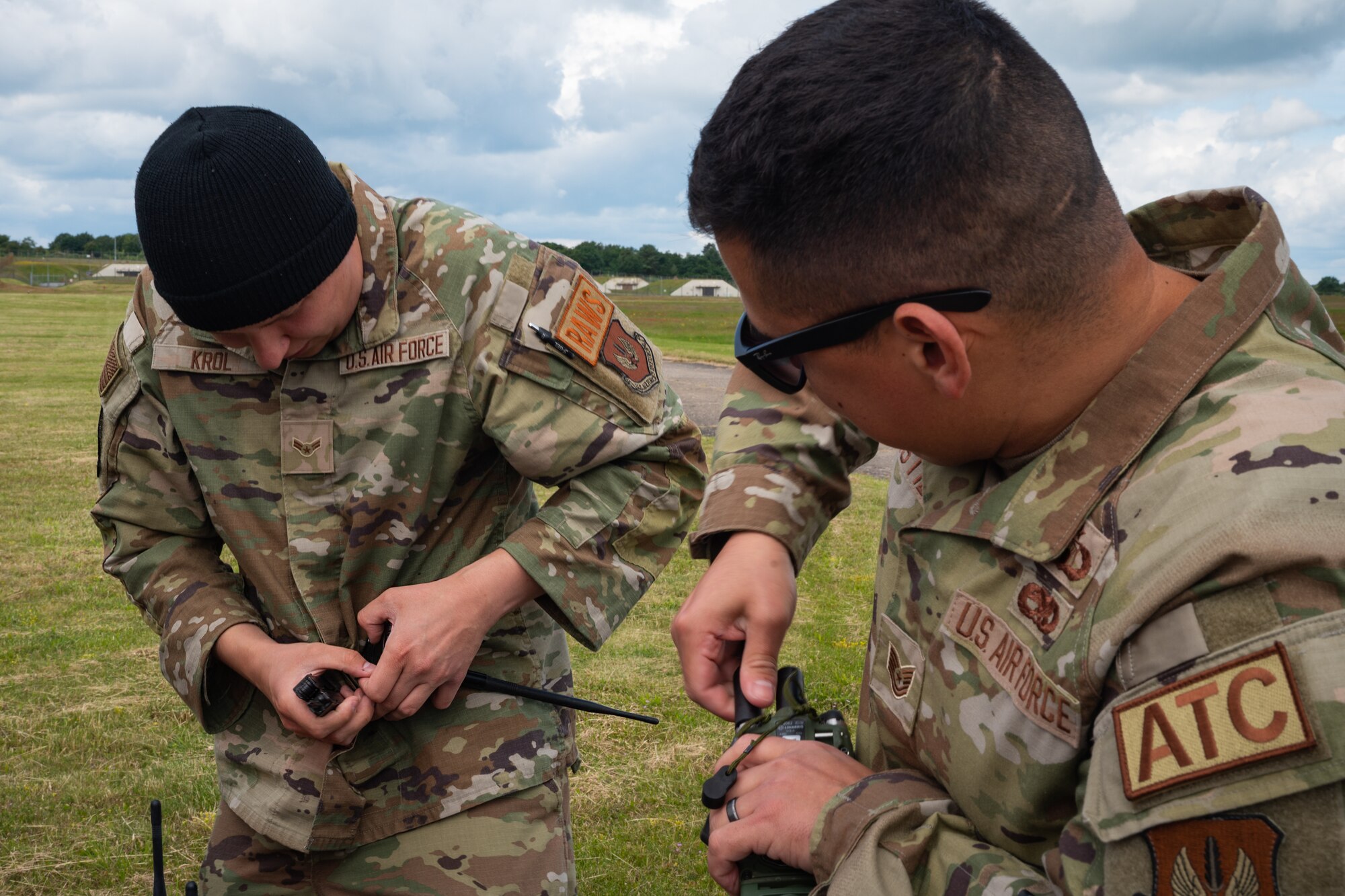 U.S. Air Force members conduct preliminary equipment checks on landing zone gear.
