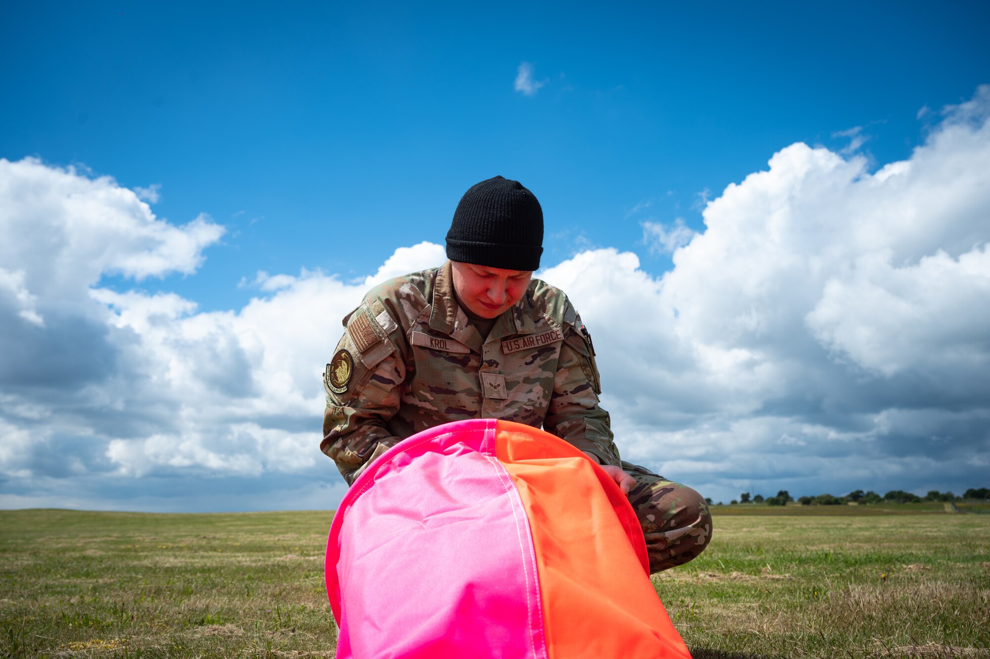 U.S. Air Force member sets up a landing zone marker panel.